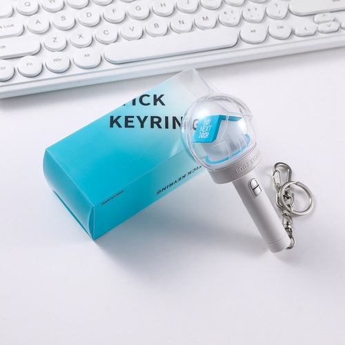 BOYNEXTDOOR mini light stick keychain displayed beside its blue box