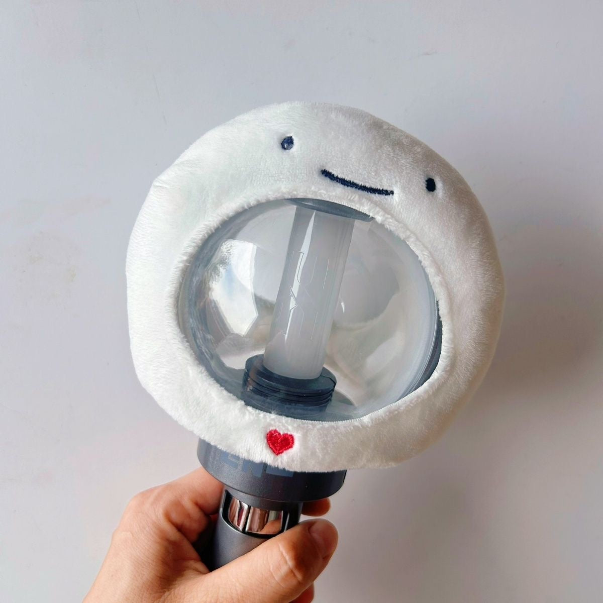 BOYNEXTDOOR character light stick cover shown fitted around the globe
