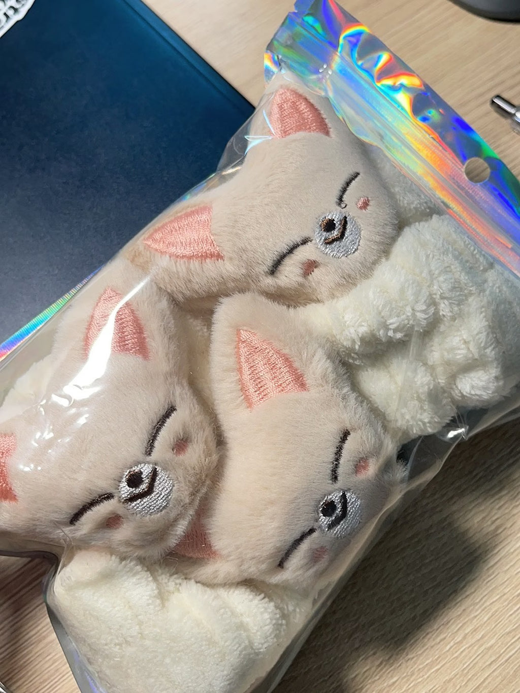 Beige character plush headband and matching wristbands in package