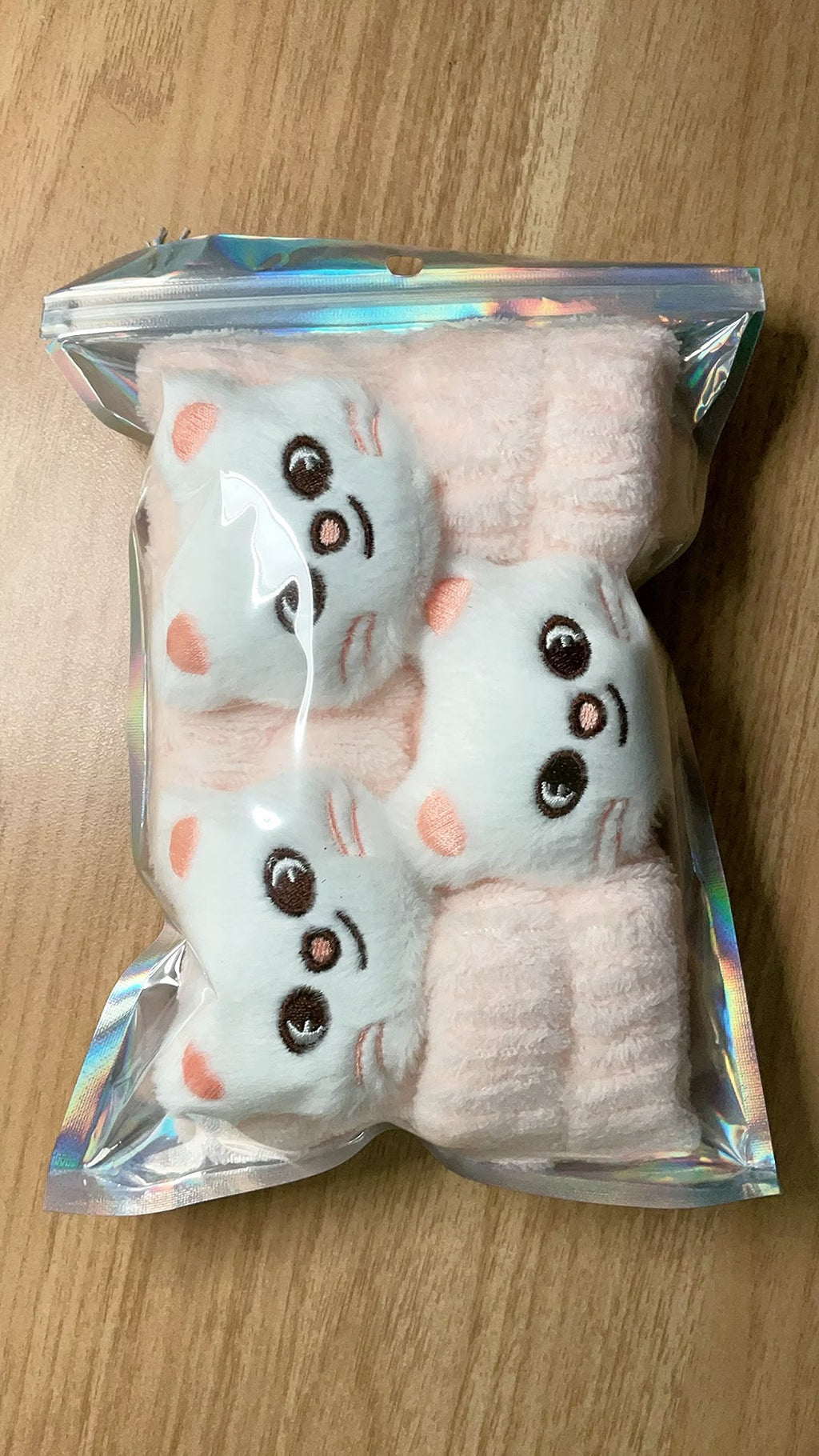 Pink character plush headband and matching wristbands in package